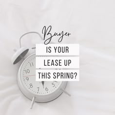 an alarm clock sitting on top of a white sheet with the words buyer is your leases up this spring?