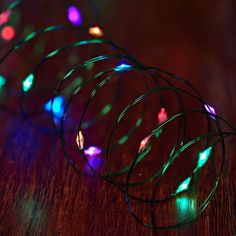 multicolored lights are arranged on a wooden surface