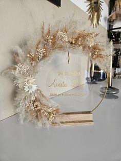 a white and gold wreath on top of a table