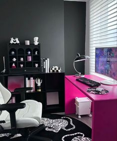 a black and white living room with pink accents on the desk, zebra print rug