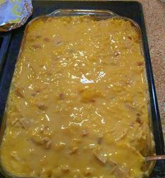 a casserole dish with meat and cheese in it sitting on a counter top