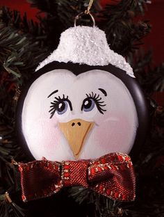 a penguin ornament hanging from a christmas tree