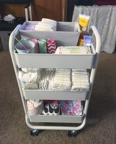 a cart filled with lots of diapers sitting on top of a carpeted floor