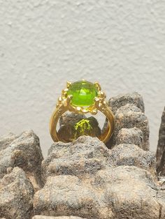 This is gold plated brass peridot ring. A designer handmade ring. It has a design of a coral, holding a green peridot gem. It could be an alternative engagement ring, or a great gift for a loving one. - 14 karat Gold plated brass - Round peridot gem - Free shipping worldwide - Sent in a gift box If you would like to see other rings I have made, please follow this link: https://www.etsy.com/il-en/shop/TamyZurTachshit?ref=seller-platform-mcnav&section_id=17271018 If you would like to go back t Luxury Green Crystal Ring In Open Ring Style, Lime Green Gemstone Ring Jewelry, Modern Gold Jewelry With Peridot, Lime Green Gemstone Ring, Peridot Ring Jewelry, Luxury Green Crystal Ring With Gemstone, Unique Peridot Jewelry For May Birthstone, Modern Gold Peridot Jewelry, Lime Green Peridot Ring