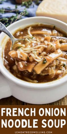 a bowl of french onion noodle soup with bread in the background