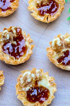 several small pies with jelly in them on a table