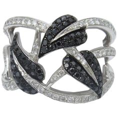 a black and white ring with diamonds on it's sides, set in 18k white gold