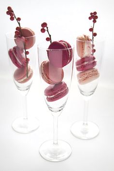 three wine glasses filled with different types of desserts