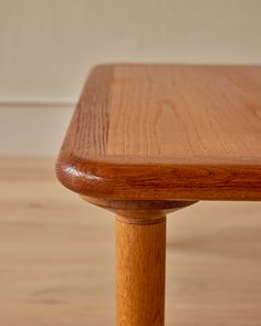 a wooden table sitting on top of a hard wood floor