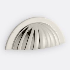 a close up view of the top of a white ceiling light fixture with curved design