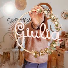 a woman holding up a sign with the word gulua spelled in front of her