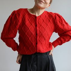 Vintage red wool Austrian cardigan. Great vin condition. Black button closure. 100% pure new wool. Made in Austria in 90's. Big sleeves. Originally women's size S / M depending on desire fit but please check measurements carefully. Classic.  Armpit to armpit laying flat 50cm=19'5 Sleeve from armpit 41cm=16' Total length 58cm=23' Model is 164cm=5'4 tall UK size 10. Red Wool Cardigan For Fall, Retro Red Winter Cardigan, Fitted Red Sweater With Button Closure, Red Retro Winter Cardigan, Red Vintage Knit Cardigan, Red Knit Cardigan With Buttons, Vintage Red Knit Cardigan, Red Knit Cardigan With Button Closure, Vintage Red V-neck Cardigan