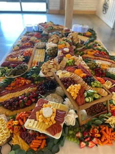 a table filled with lots of different types of food on top of eachother