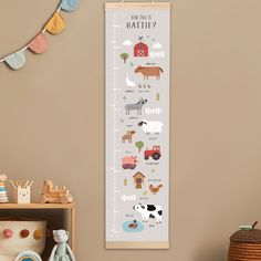 a children's growth chart with farm animals on it in a child's room