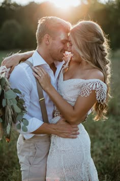 a bride and groom laughing together in the snow