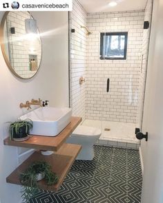 a bathroom with black and white floor tiles