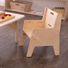 a child's wooden chair and table in a playroom