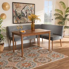 a room with two green couches and a wooden table in front of a painting