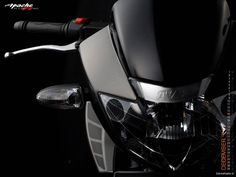 the headlight and handlebars of a motorcycle in black background with text above it