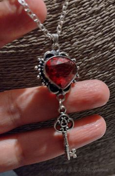 Welcome to a Kiss of Romance with this beautiful.  Key to my Heart Necklace. This Faux Ruby is Bezel set in sterling silver with an antiqued finish for a timeless look.  Alternative never looked so beautiful you will look enchanting whether you wear these with heels, jeans and a t-shirt or a beautiful Gothic gown... The focal point measure 3"inches long x 1 inch wide.  Faux Ruby is a deep red with deep pink tones.  These will look magical worn.  ( Please note: Due to health and hygiene the match Gothic Heart Necklace, Gothic Gowns, Gothic Heart, Heart Necklace Silver, Steampunk Necklace, Gothic Necklace, Crystal Jewellery, Key To My Heart, Necklace Crystal