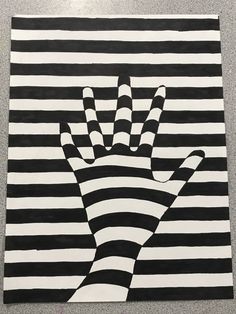 a black and white striped painting with a hand on it's left side in the middle