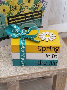 a box with a ribbon tied around it sitting on a table