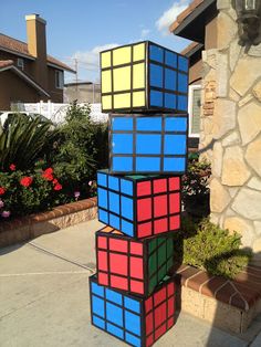 a rubik cube is stacked on top of each other in front of a house