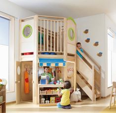 two children playing in a play room with bunk beds, stairs and storage space for toys