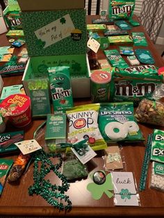 the table is covered with many different items for st patrick's day celebrations, including candy and snacks