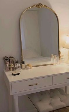 a white vanity with a mirror and drawers