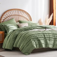 a bed with green comforters and pillows in a room next to a wicker headboard