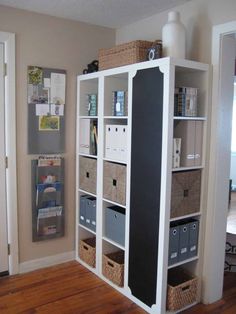 a white bookcase filled with lots of boxes and baskets on top of it's sides