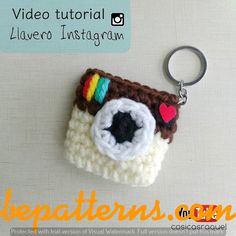 a crocheted camera keychain is shown with the words video tutor on it