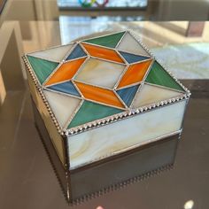 a decorative box sitting on top of a glass table