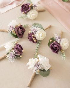 wedding bouquets with purple and white flowers on a table