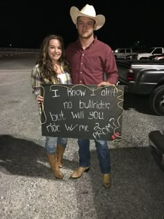 a man and woman holding a sign that says, i know i am no bulldozer but will you ride with me?