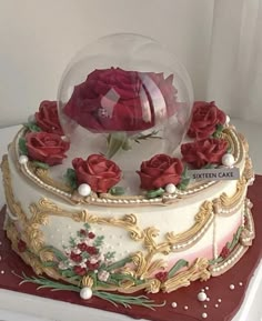 there is a large cake with roses in the snow globe on it's side