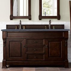 a bathroom vanity with two mirrors above it