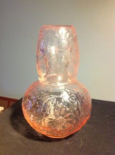 a glass vase sitting on top of a table