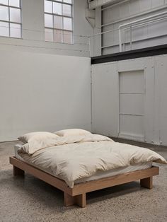 an unmade bed sitting in the middle of a room