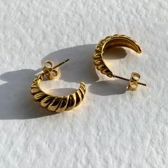 Gold croissant twist earrings. Make a subtle statement with these vintage style hoops Earring height is approx 19mm Earring width is approx 7mm (at widest point)  Made of stainless steel with a gold PVD coating. Sold as a pair!  Matching ring available from our store! Why not purchase as a gift for a loved one ? We never include invoices when sending out an item and can add a gift message if you let us know at checkout. All items are packaged in a plush branded pouch. If you are purchasing multi Twisted Earrings, Earrings Gold Hoops, Twist Earrings, Mini Twists, Hoops Gold, Matching Ring, Matching Rings, Gold Hoops, Jewelry Earrings Hoops