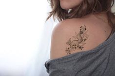 a woman with a tattoo on her shoulder