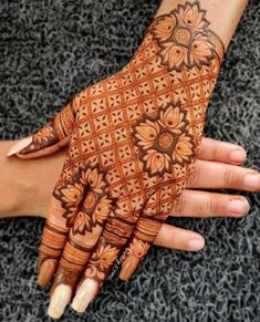 two hands with henna designs on them