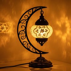 a lamp that is sitting on top of a table next to a moon and stars