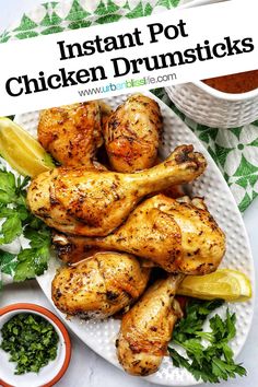 instant pot chicken drums on a plate with garnishes and dipping sauces