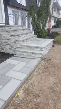 the steps are being laid out on the side of the house to be built into the sidewalk