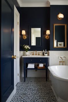 a bath room with a tub a sink and a mirror on the wall in it