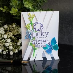 there is a card that says lucky to have a sister like you with butterflies on it