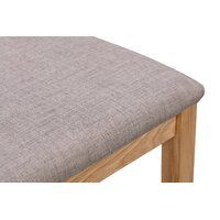 a close up of a wooden bench cushion