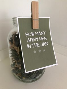 a jar filled with army items and a sign that says how many army men in the jar